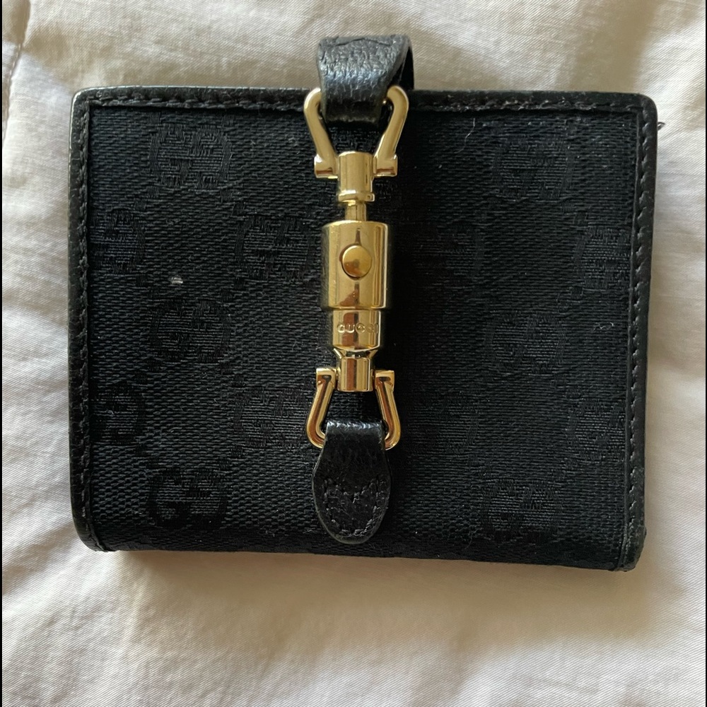 Black Gucci wallet. MINOR mark on front. See pics.
